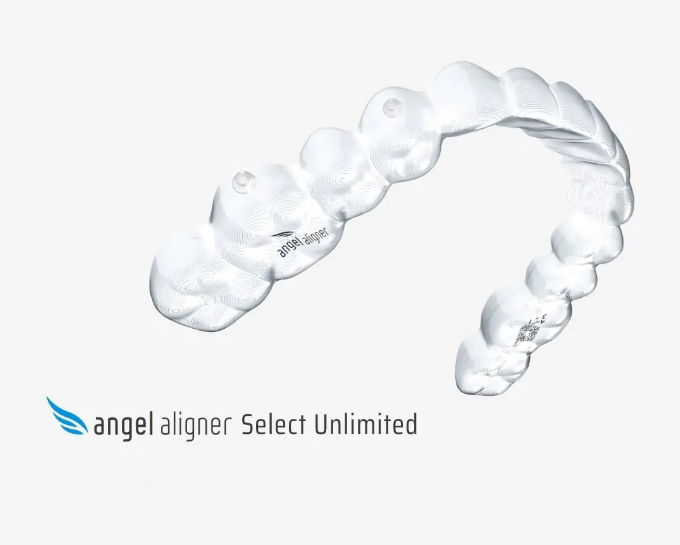 Close up of a hand holding a clear aligner