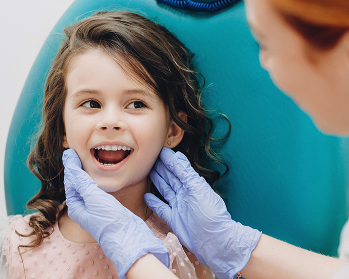 Orthodontist examining a young girls teeth