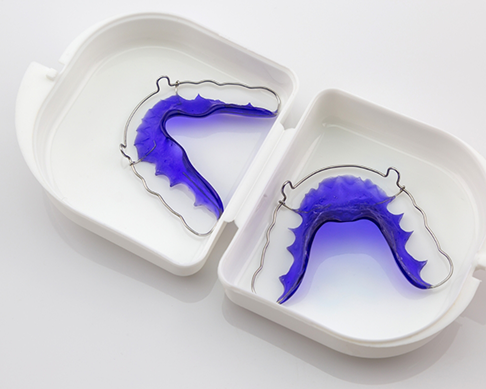 White plastic case with a set of removable retainers