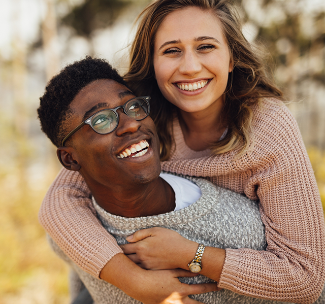 Smiling young man and woman hugging after receiving orthodontic services in Gilbert