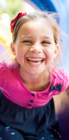 Young girl in pink shirt laughing