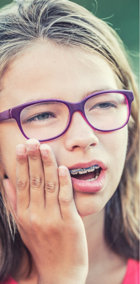 Smiling teenage girl with glasses and long blonde hair