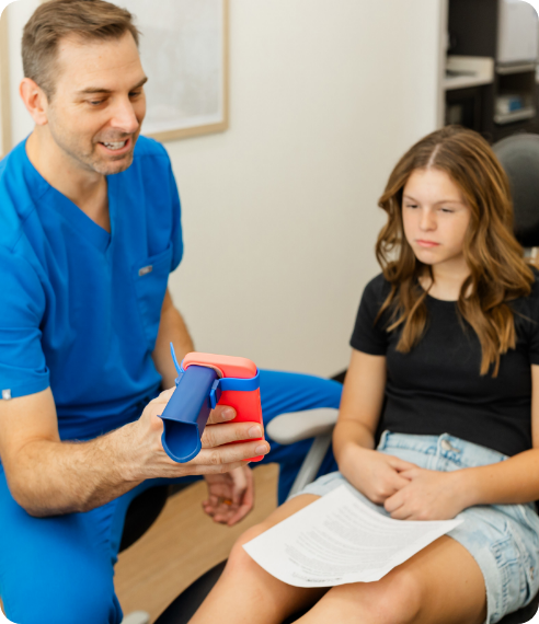woman holding invisalign