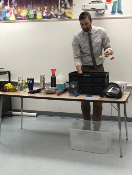 Doctor Larson setting up science equipment on a table