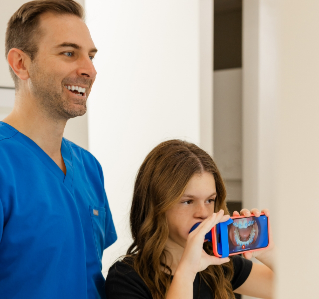 Gilbert orthodontist showing a tablet to a patient