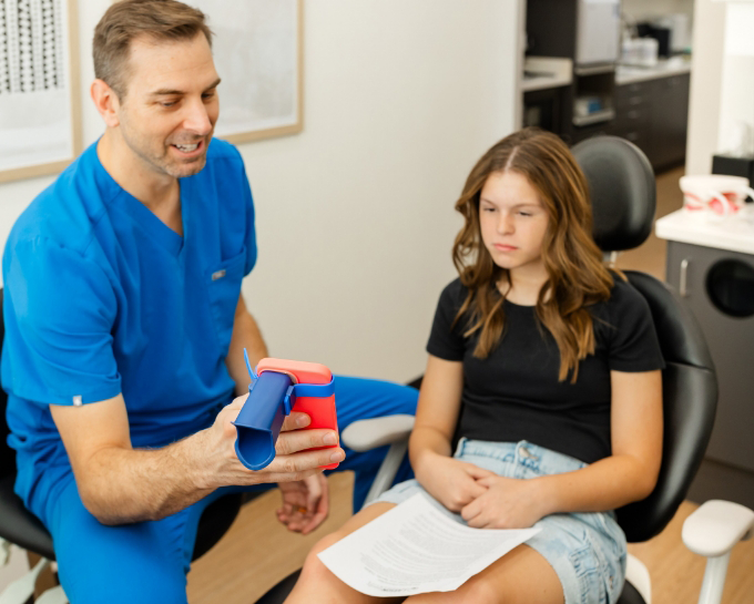 Two dental professionals looking at a tablet together